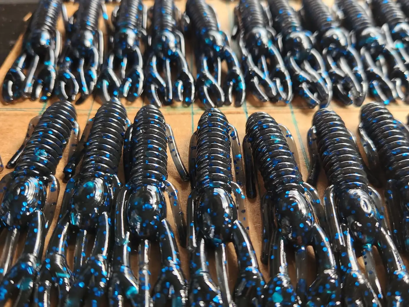 Rows of freshly poured black and blue craws cooling on the bench